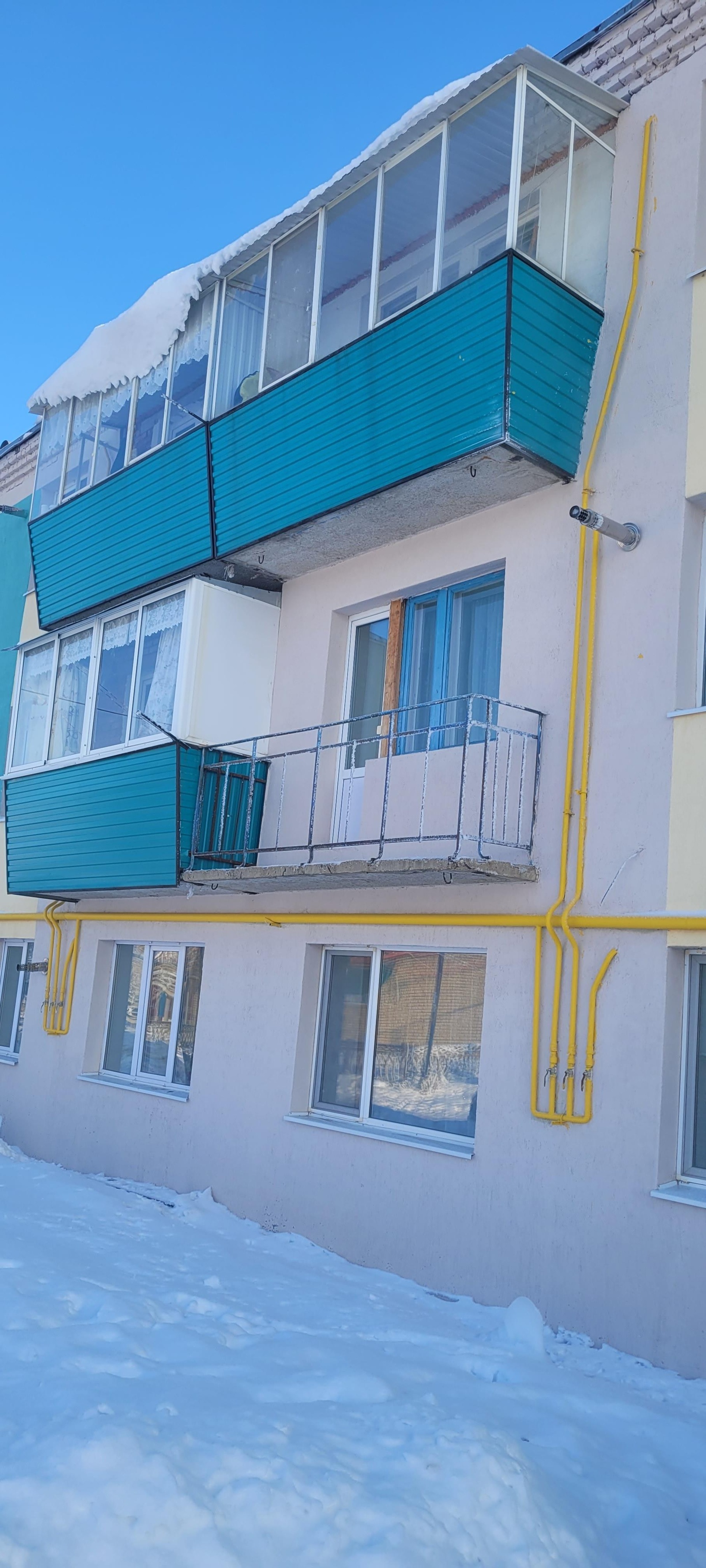 Балконы с бирюзовой наружной отделкой, вид сбоку.